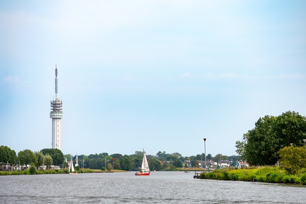 Sailing boat on the Maasplassen with the Roermond TV tower in the background